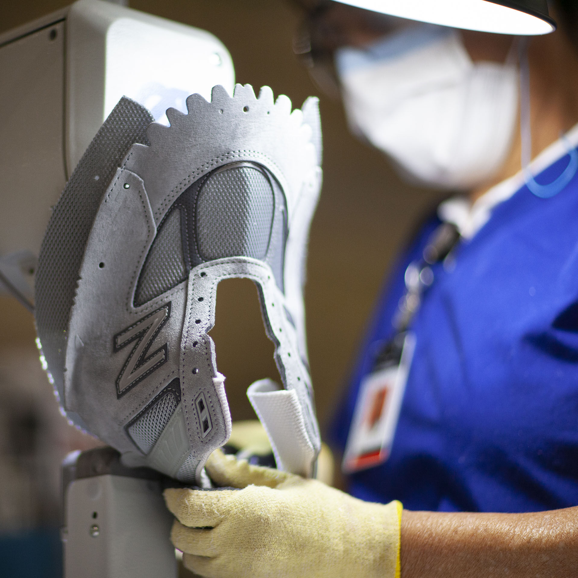A worker handing a piece of equipment to another worker