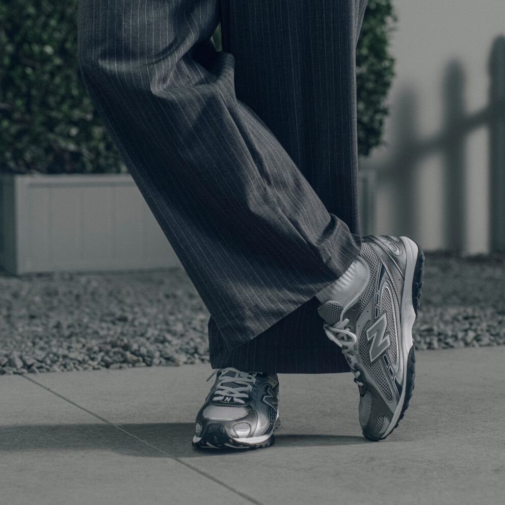 Knee down image of a person wearing a pair of grey 204L